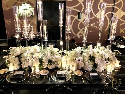 Mirrored sweetheart table with crystal candelabras and lush white florals