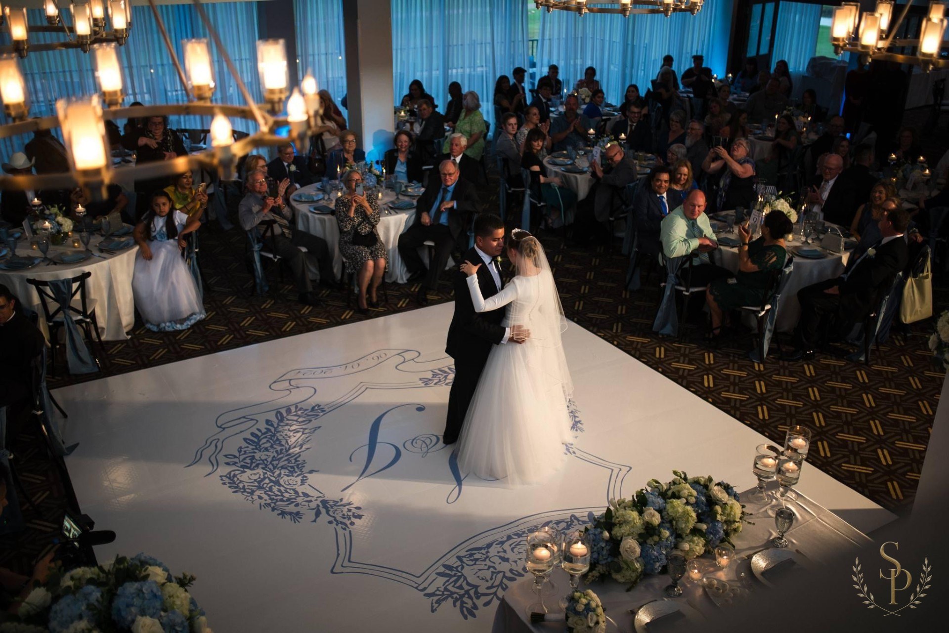 Custom monogrammed dance floor and reception in soft blues