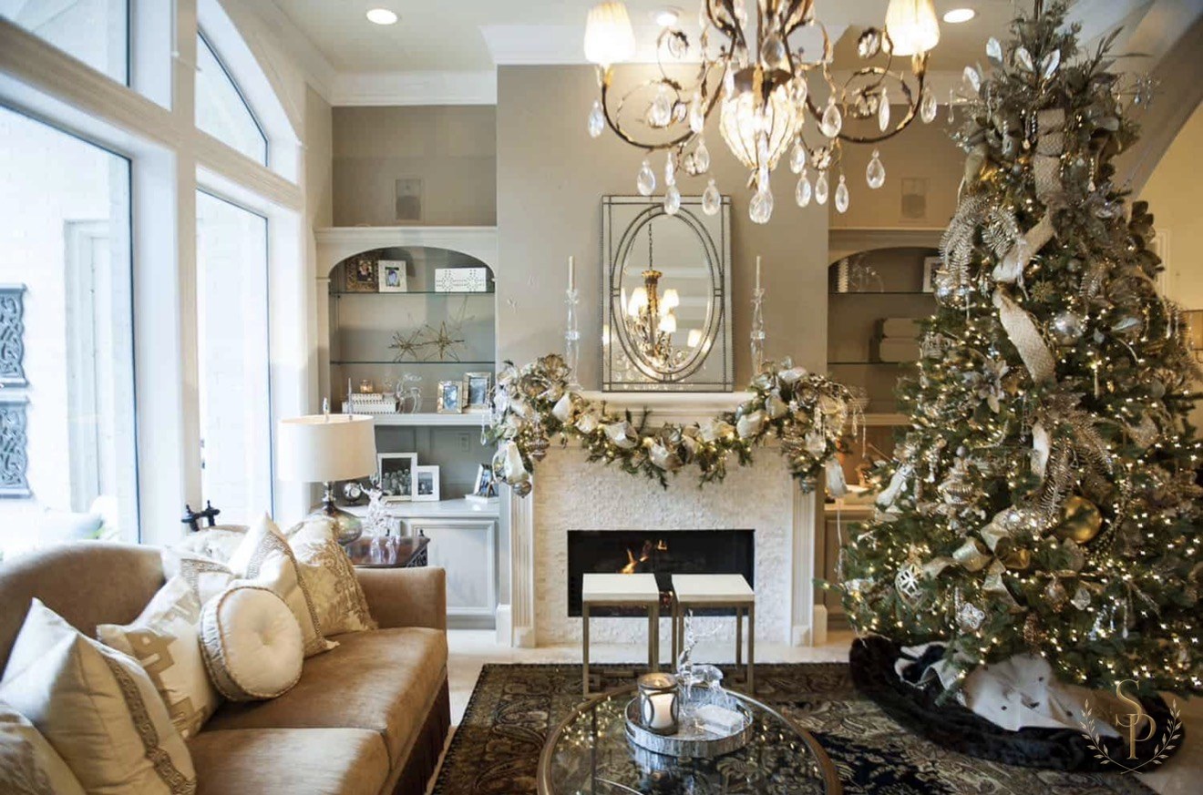 Elegant champagne and silver Christmas living room with mantel garland
