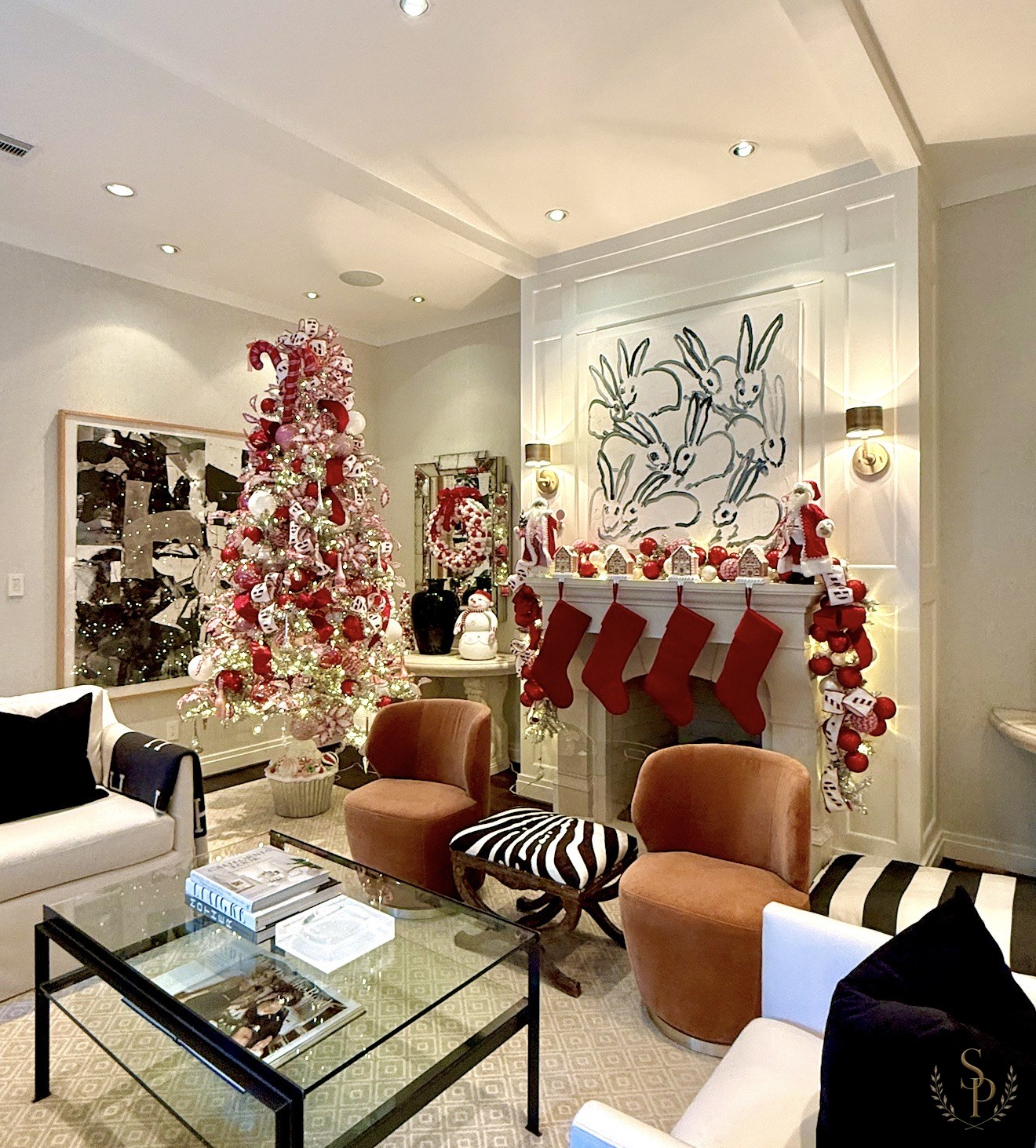 Red and white candy-stripe living room tree with stocking-lined mantel