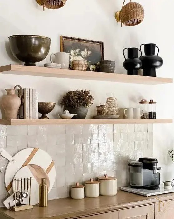 Styled open shelving with collected pottery, books, and a small landscape painting
