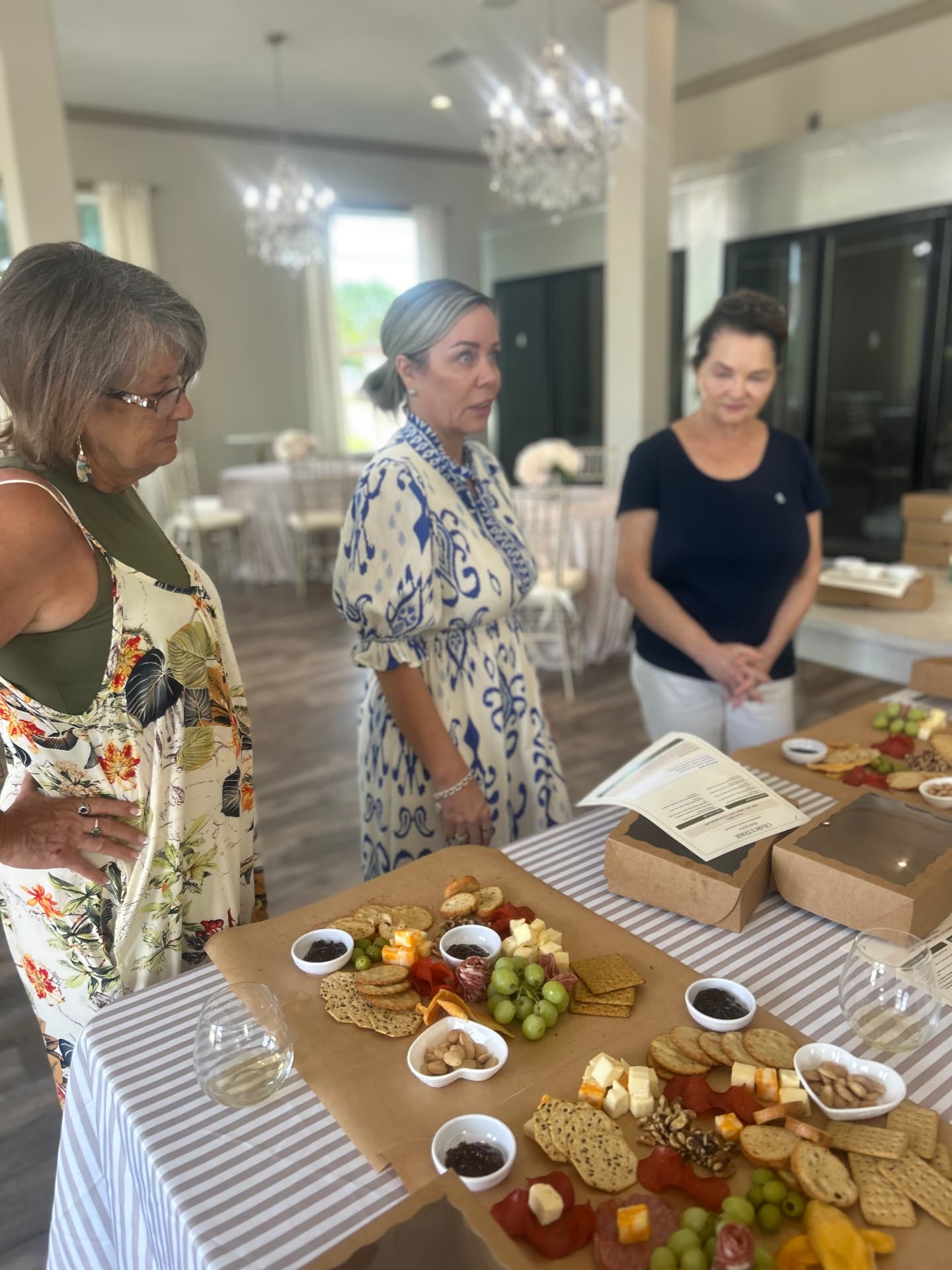 Hands-on charcuterie styling class around a striped-linen table