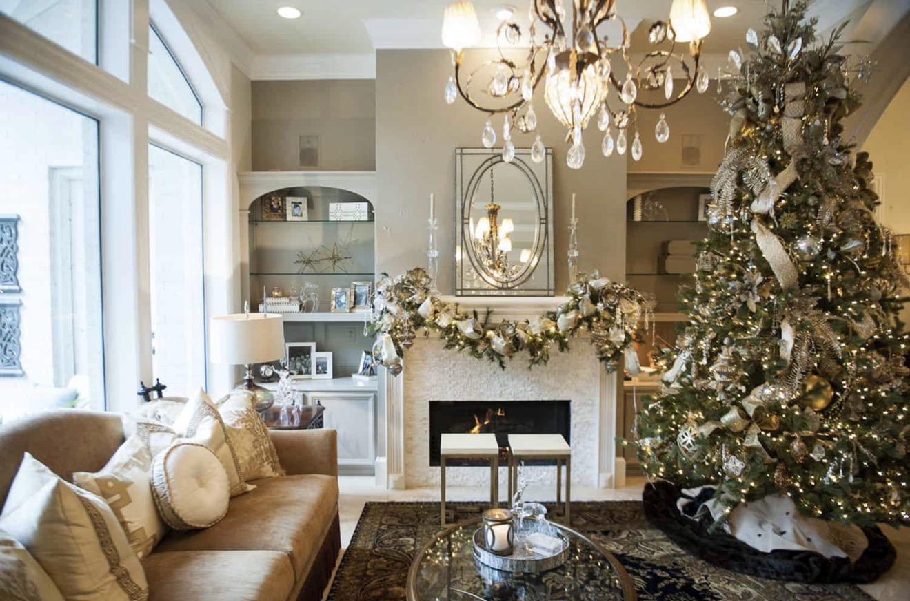Elegant champagne and silver Christmas living room with mantel garland