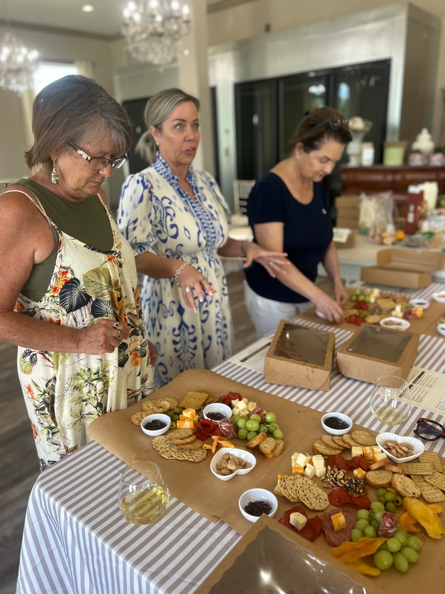Guests styling their own charcuterie boards during a hands-on class