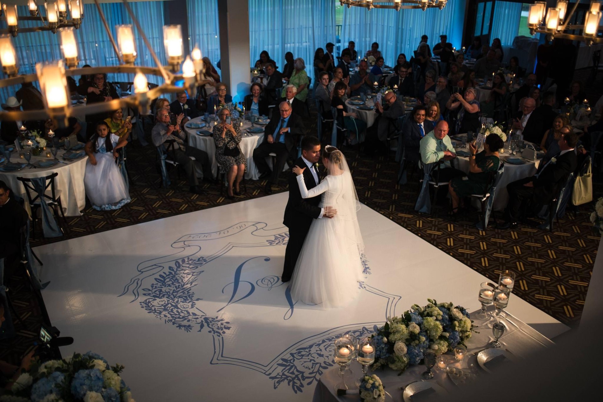 Custom monogrammed dance floor and reception in soft blues